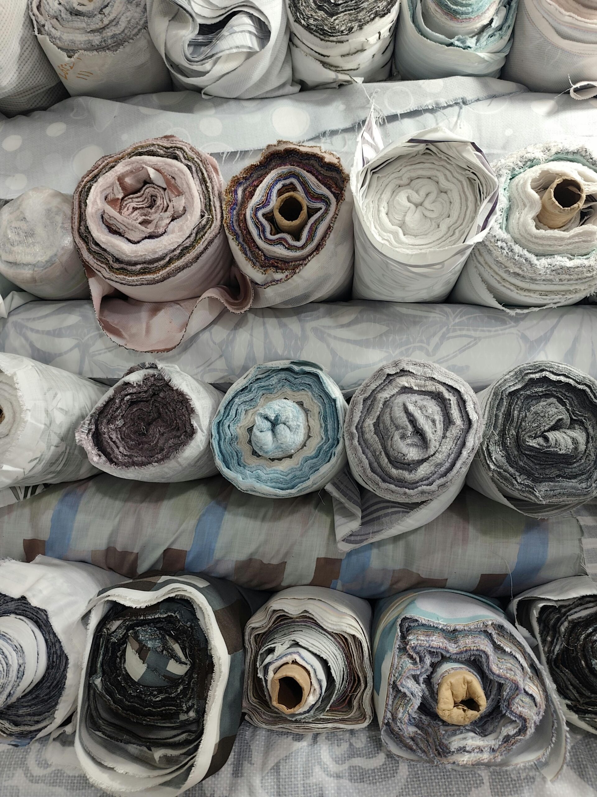 High-Grade Fabric & Textile Vibrant rolls of fabric stacked neatly accentuating textile diversity.