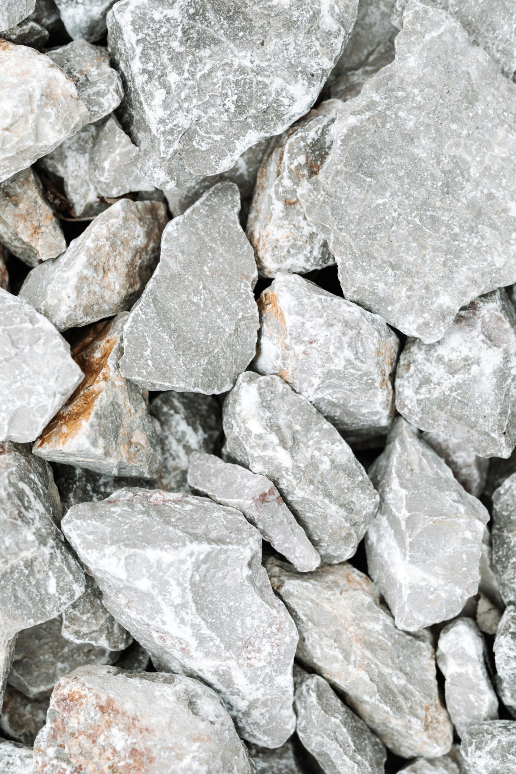 High-Purity Natural Gypsum Close-up of natural rough slate stones in a vertical composition, showcasing texture.