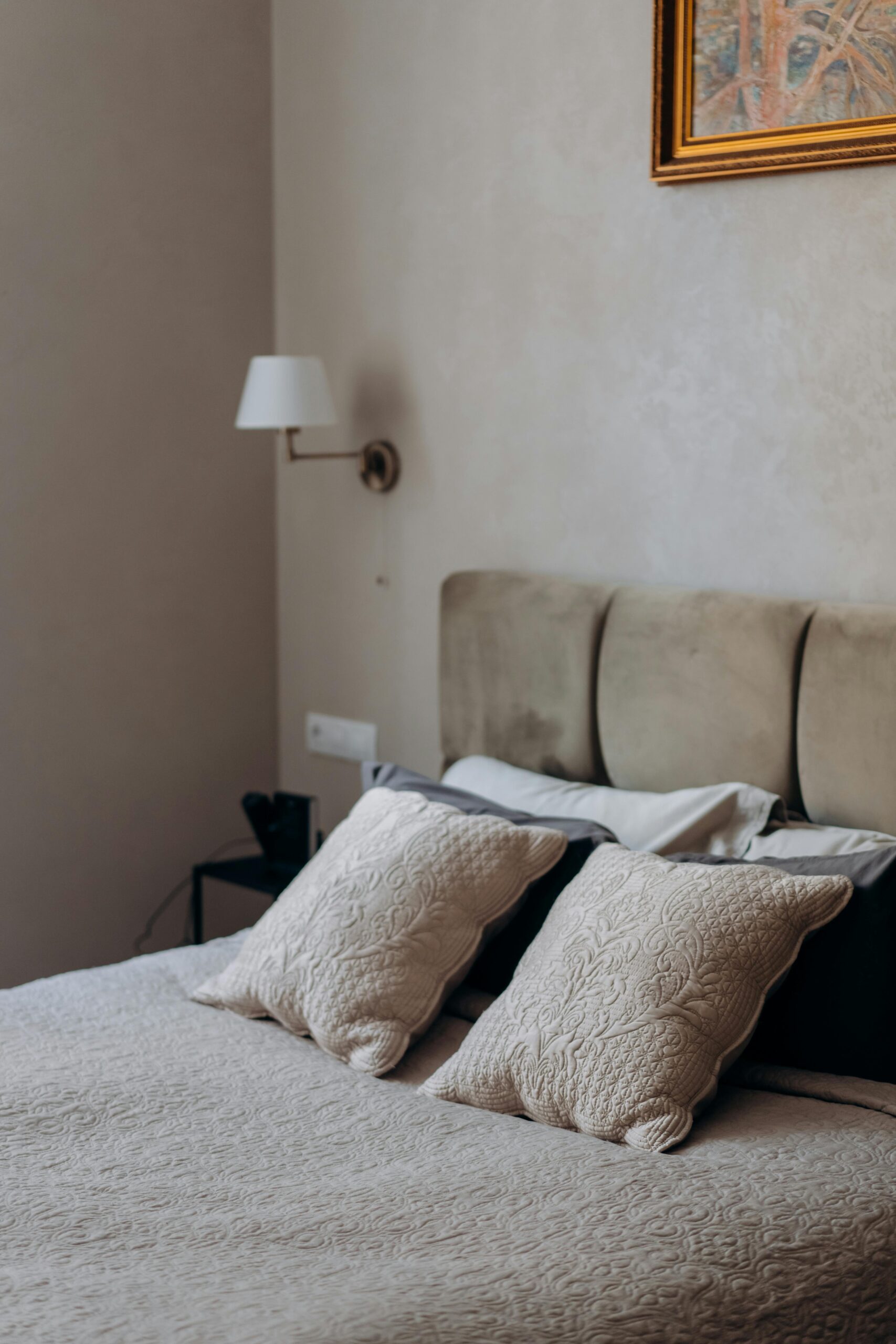 Premium Pillow Covers & Luxury Bedding Cozy and elegant bedroom interior showcasing minimalist design with a focus on bedding and wall art.